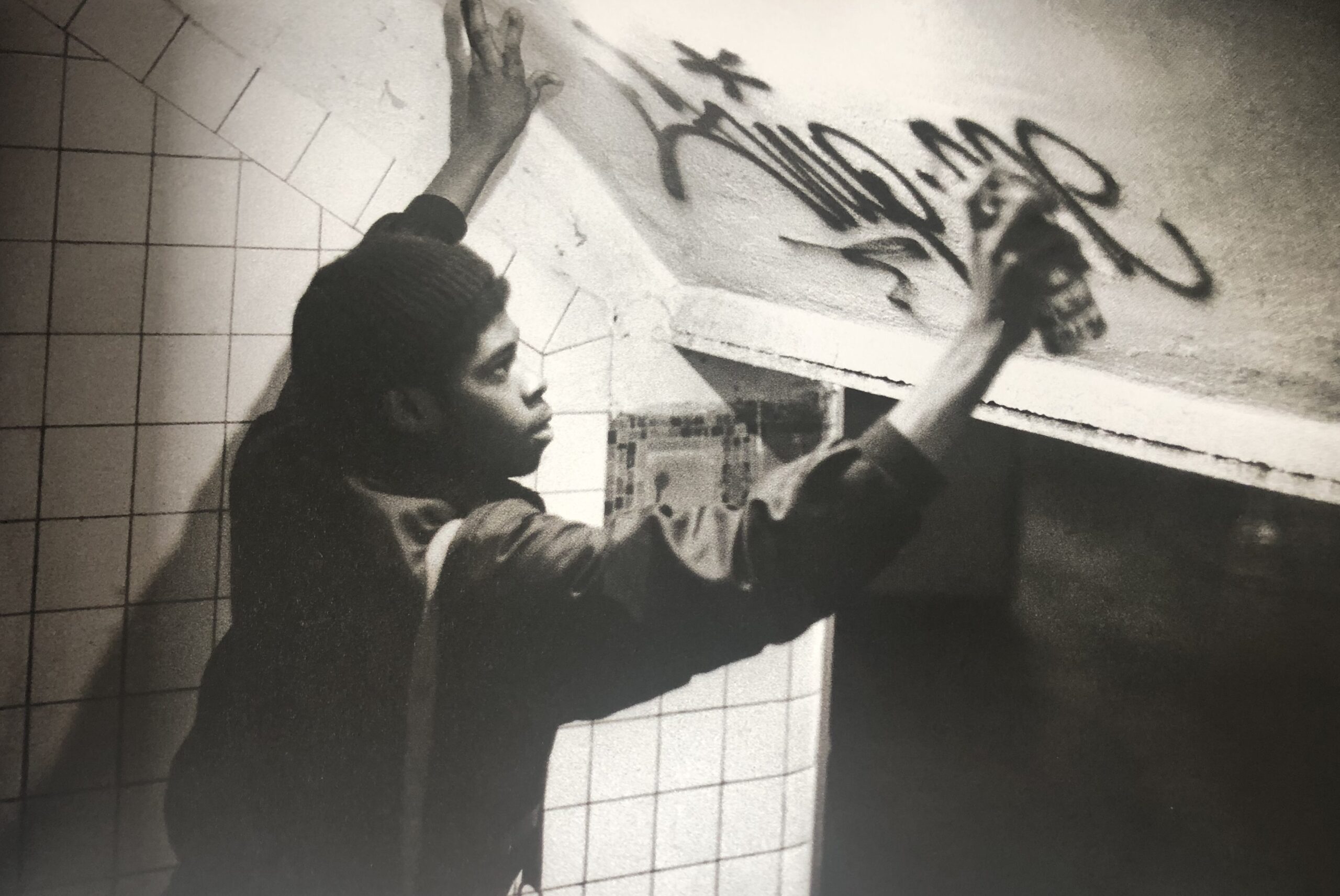 Flint Gennari, Jeune homme apposant un graffiti dans le métro de New York, 1974.