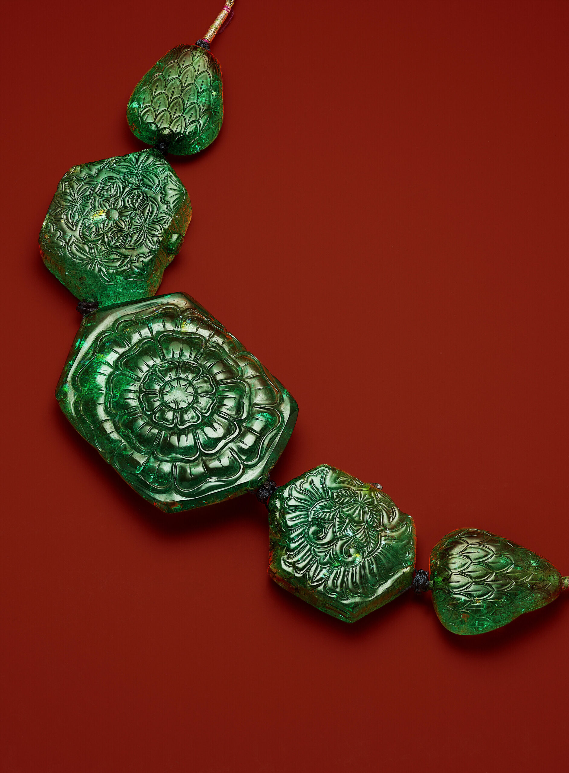 Mughal necklace of engraved emeralds comprising three hexagonal-cut stones and two pear-shaped emeralds of approximately 470.00, 294.00, 199.50, 108.50 and 106.50 carats, circa 1750; later-added silk cords; the largest emerald bearing the inscription “Ahmad Shah Durr-i Durran” (“Pearl of Pearls”). SSEF, 2022, report no. 126237: Colombian origin; clarity enhancement by oil, ranging from minor (C) to moderate (A, B, D, E) at the time of testing; accompanied by an appendix letter. Gross weight: 240.2 grams. Estimate: USD 2,000,000 – 3,000,000. Lot 44. Christie’s New York, June, 17, 2025.
